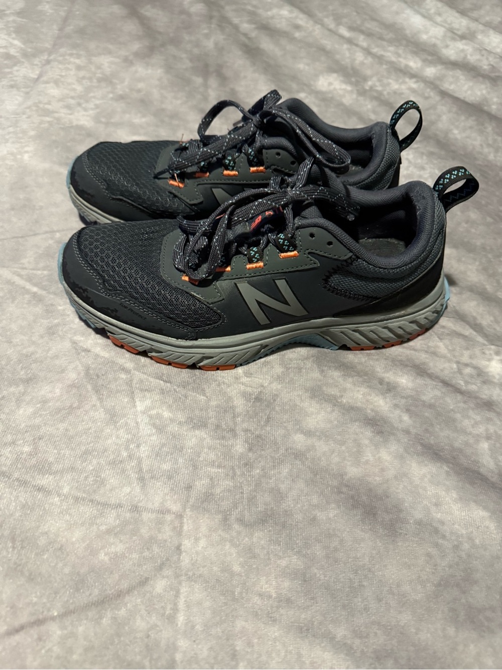 New Balance Black and Gray Trail Sneakers with Orange Accents